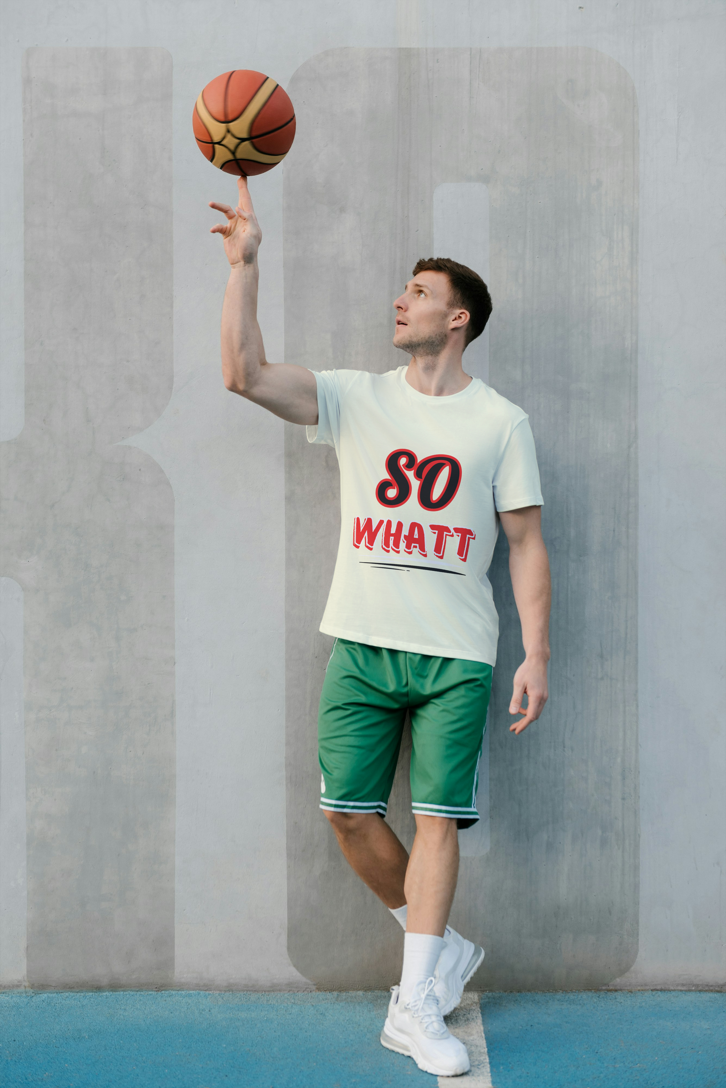 Person holding a basketball in a casual pose against a plain background