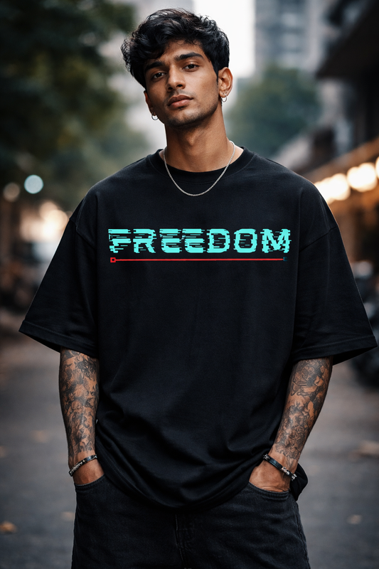 Man wearing a black t-shirt with 'FREEDOM' printed on it, standing outdoors.